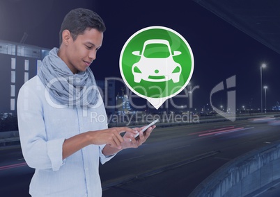 Man holding phone with car icon on city road
