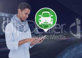 Man holding phone with car icon on city road