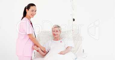 Doctor woman with patient with breast cancer awareness ribbon