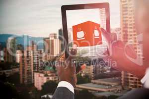 Composite image of cropped image of businessman using digital tablet