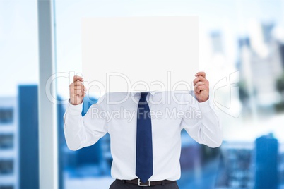 Business man holding blank card in office