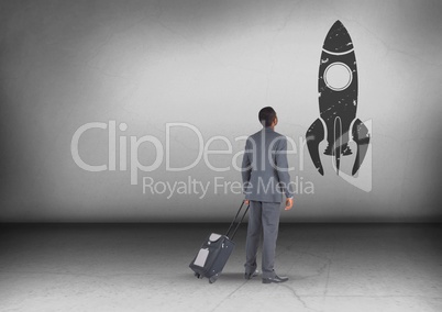 Businessman with travel bag looking up with rocket icon