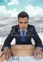 Businessman using keyboard in sea of documents under sky clouds