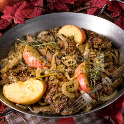 Fried liver with onion apple and herbs.