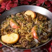 Fried liver with onion apple and herbs.