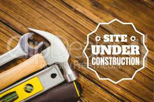 Website under construction text against tools photo