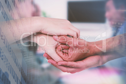 Composite image of cropped hands holding together