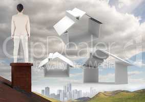 Businesswoman on roof with home  icons over city