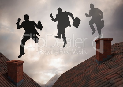 Businessman silhouette jumping on Roofs with dramatic light cloudy sky