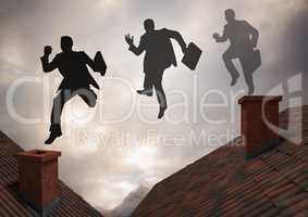 Businessman silhouette jumping on Roofs with dramatic light cloudy sky