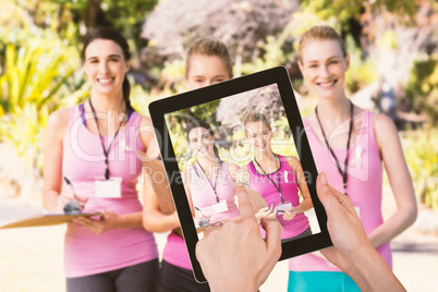 Composite image of hands touching digital tablet against white background