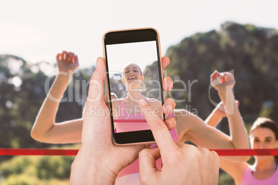 Composite image of hands touching smart phone