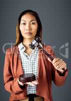 Female judge with gavel against grey background