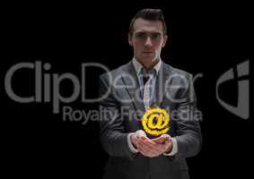 businessman with hands spread of with @ fire icon over. Black background