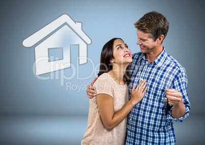 Couple Holding key with house icon in front of vignette