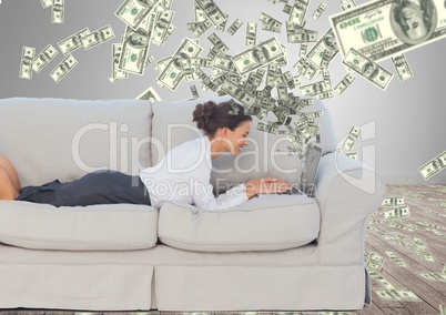 texting money. happy young woman on the sofa with laptop. Money coming up from laptop.