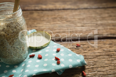 Oatmeal in jar on wooden table