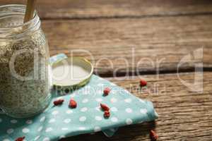 Oatmeal in jar on wooden table