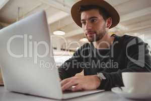 Businessman using laptop in cafe