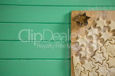 Directly above shot of star shape cookies on cutting board