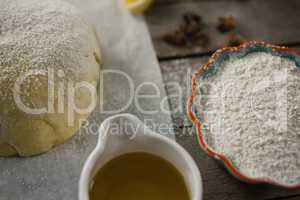High angle view of dough and flour with cooking oil