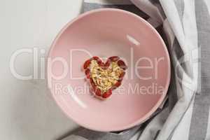 Dried fruits forming heart shape in plate