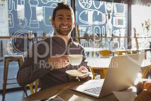 Portrait of businessman having coffee in cafe