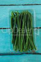 Garlic chives in plastic container