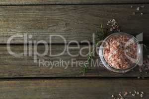 Himalayan salt and rosemary on wooden table