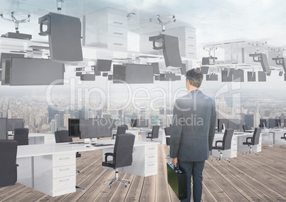 businessman standing in inverted office with skyline