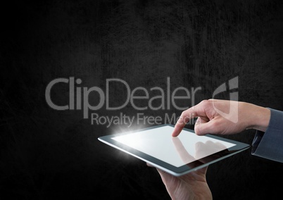 Hand holding tablet with glow