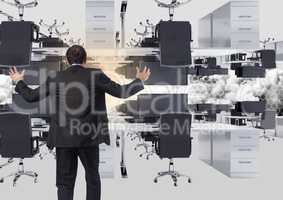 businessman standing in inverted office in clouds with flare