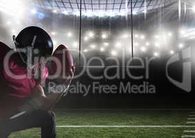 american football  player kneeling in stadium