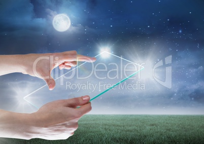 Hand holding glass tablet with glow and moon