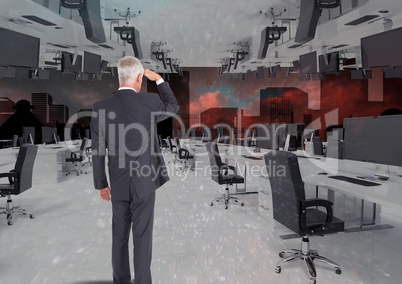 businessman standing in inverted office with skyline