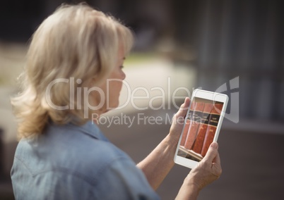 woman using bookshelf on tablet screen