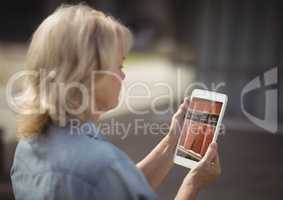 woman using bookshelf on tablet screen