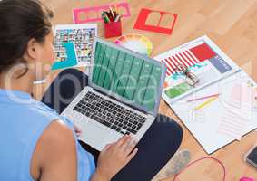 woman using bookshelf on laptop screen