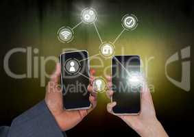 Hands holding phones with icons interface of internet of things