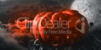 Composite image of jack o lantern with leaves on table