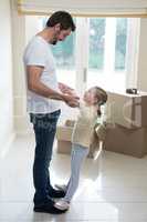 Father and daughter having fun in living room