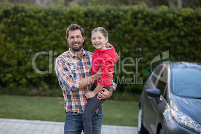 Father carrying his daughter in his arms