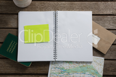 Passport, map, organizer and envelope on wooden table