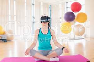 Woman performing yoga while using virtual reality headset