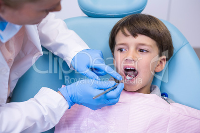 Dentist examining boy at clinic