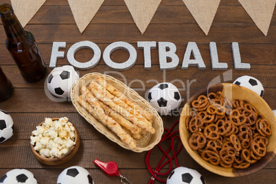 Football text and snacks on wooden table