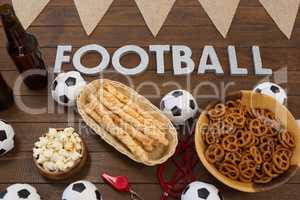 Football text and snacks on wooden table