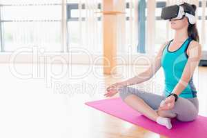 Woman performing yoga while using virtual reality headset