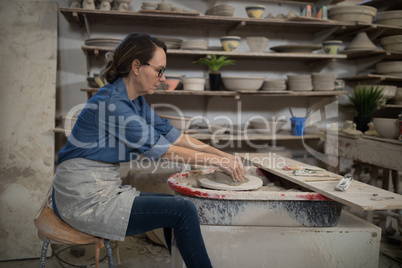 Female potter molding clay