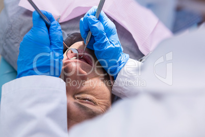 Close up of doctor giving dental treatment to man
